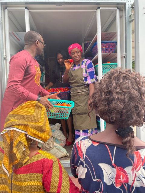 Traders handing out baskets of produce at the cold room door